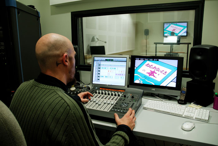 man working in dubbing booth